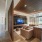 Leather couch with large TV and floor to ceiling window.